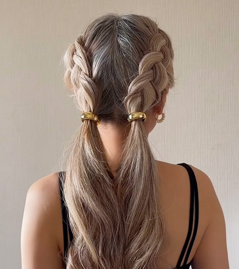 KELA Ponytail Halo Hair Clip Ponytail Holder in gold finish securing two blonde braided ponytails with a polished, tension-free hold