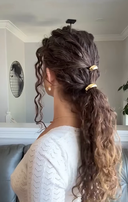 Brown curly hair styled in a ponytail secured with two small gold KELA Ponytail Halo Hair Clip Ponytail Holder accessories